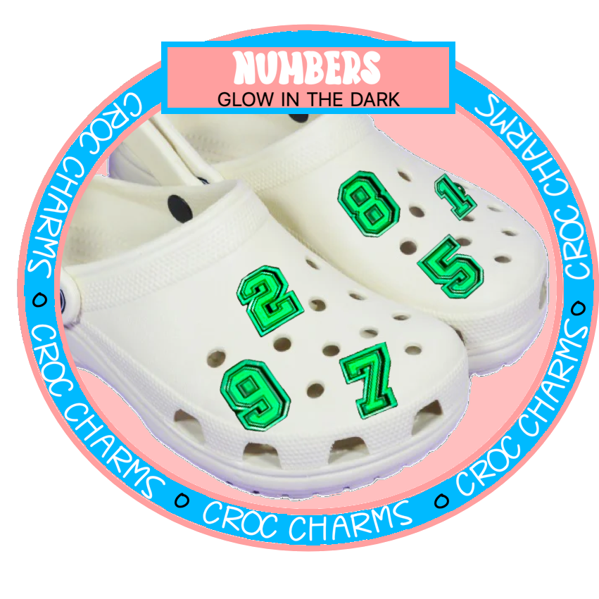 White Crocs shoes decorated with green glow in the dark shoe charms shaped as numbers